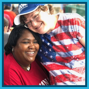 Curlie, Group Home Manager hugging an individual served. Both dressed in Red and white patriotic clothing